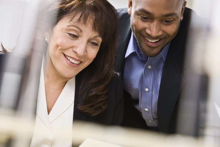 Stock Photo of man and woman smiling looking at something