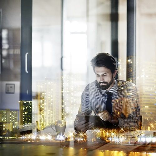 Stock photo of man looking through tablet